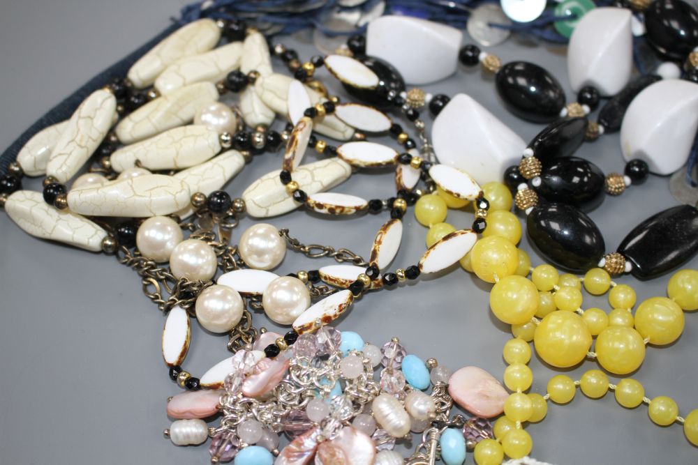 Six assorted costume necklaces including simulated amber and a costume bracelet,